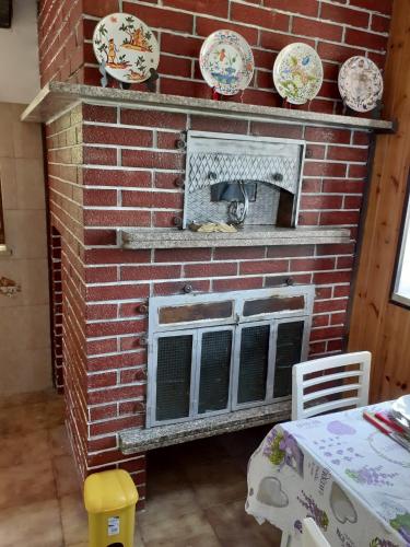 a brick fireplace with a cat sitting inside of it at Villa Ambra in Vigolo