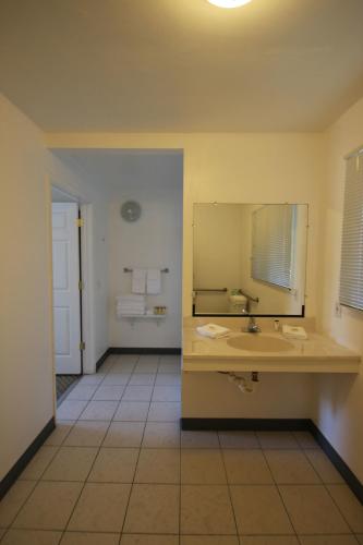 a bathroom with a sink and a mirror at Redwood Inn in Santa Rosa
