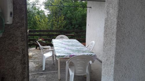 a table and chairs on a balcony with a table and a table and chairs at Villa Ambra in Vigolo
