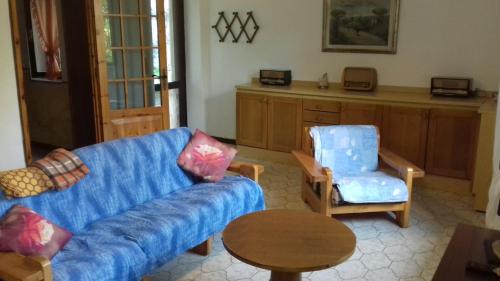 a living room with a couch and a chair and a table at Villa Ambra in Vigolo