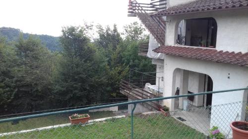 a white house with a fence in front of it at Villa Ambra in Vigolo