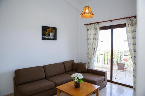 a living room with a couch and a table at VILLA LAMBRIANA in Peyia
