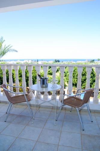 a patio with a table and two chairs on a balcony at VILLA LAMBRIANA in Peyia