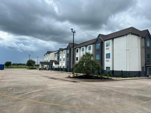 a row of apartment buildings in a parking lot at Crystal Inn in Port Arthur