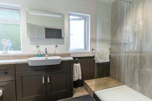 a bathroom with a sink and a shower at Finest Retreats - Hillview House in Minehead
