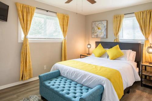 a bedroom with a large bed and a blue chair at Cute Apt near Atlanta Airport-3A in Atlanta