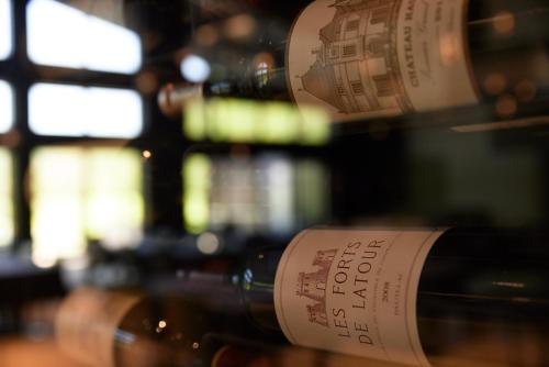 a bunch of wine bottles are lined up in a row at Asama Kuzanbo in Naganohara
