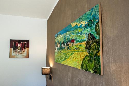 a painting hanging on a wall in a room at Terre Etrusche Guest House-Terme -3 minuti da Viterbo centro in Viterbo