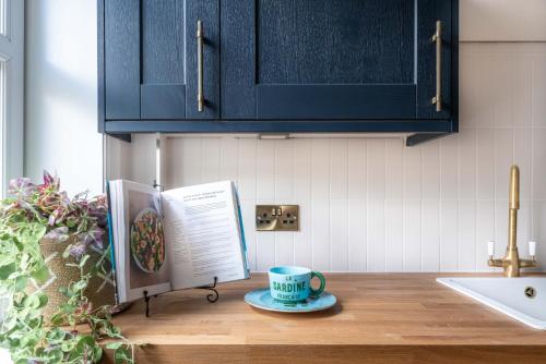 a cup of coffee on a counter in a kitchen at The Seelies - Luxury Aparthotel - By The House of Danu in Kingussie