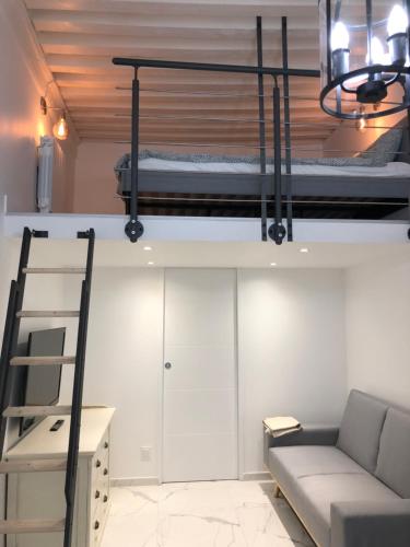 a living room with a bunk bed and a couch at L Ancien Canut Cosy in Lyon