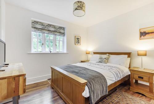 a bedroom with a bed and a window at Ramblers in Marnhull