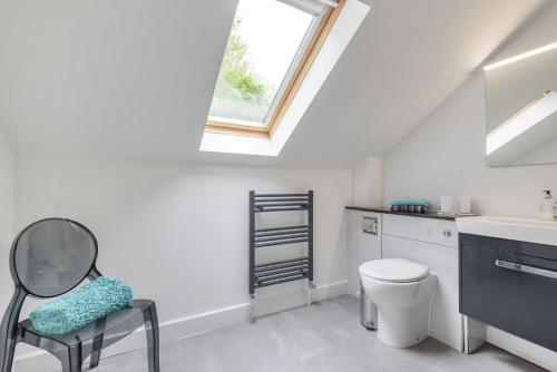 a bathroom with a sink and a toilet and a window at Ramblers in Marnhull