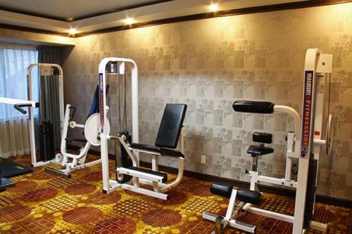 a gym with several tread machines in a room at LA Crystal Hotel -Los Angeles-Long Beach Area in Carson
