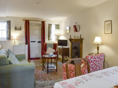 a living room with a couch and a fireplace at The Wee Hoose in Kinghorn