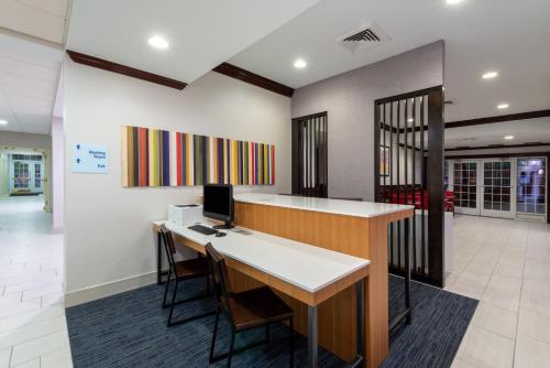 an office with a desk and a computer on a wall at Holiday Inn Express State College at Williamsburg Square by IHG in State College