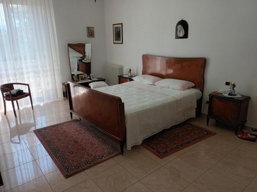 a bedroom with a large bed and two night stands at La CASA degli IPPOCASTANI in Colonnella
