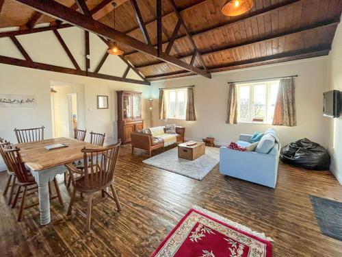 a large living room with a table and chairs at The Old W I Hall in Staunton in the Vale