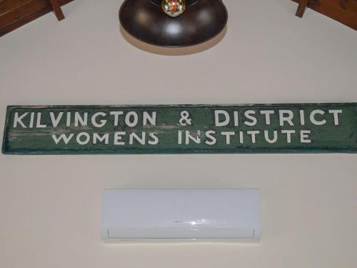 a sign hanging from the ceiling of a room at The Old W I Hall in Staunton in the Vale