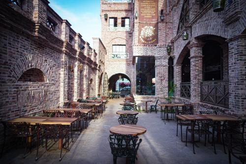 an alley with tables and chairs in a building at Terra Firma Hotel Boutique in Villa Carlos Paz