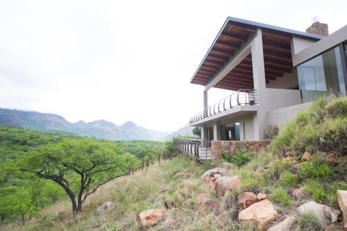 a house on the side of a hill at umVangati House in Hoedspruit
