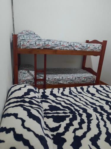 a bed with a zebra print blanket on a shelf at Terencio in Goya