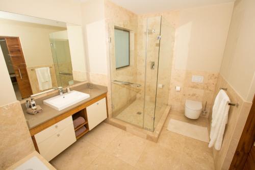 a bathroom with a shower and a sink at umVangati House in Hoedspruit