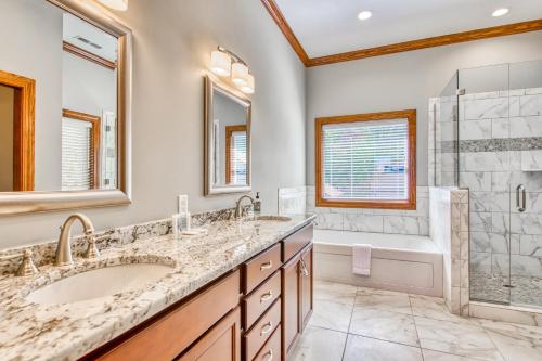 a bathroom with two sinks and a shower and a tub at Altitude with Gratitude in Whittier