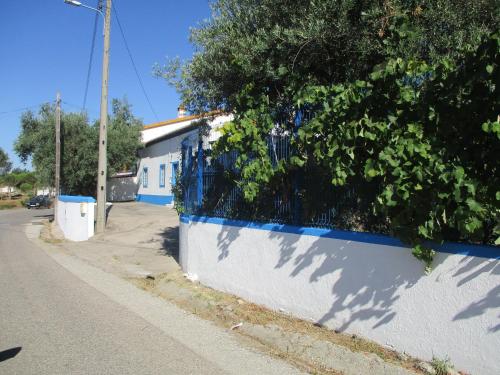 a fence with a tree on the side of a street at CASA DA ALDEIA - Ponte de Sor (Alentejo) in Ponte de Sor