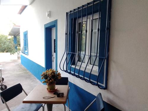 a table and chairs sitting next to a window at CASA DA ALDEIA - Ponte de Sor (Alentejo) in Ponte de Sor
