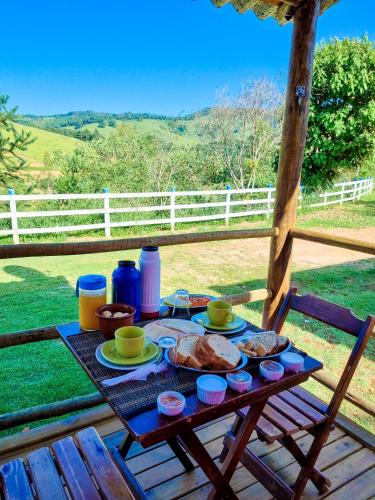 a picnic table with food on top of a porch at Pousada Recanto dos Bentos in Itapeva