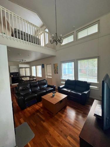 a living room with a couch and a coffee table at Pan Golf & Spa Villas in Imatra
