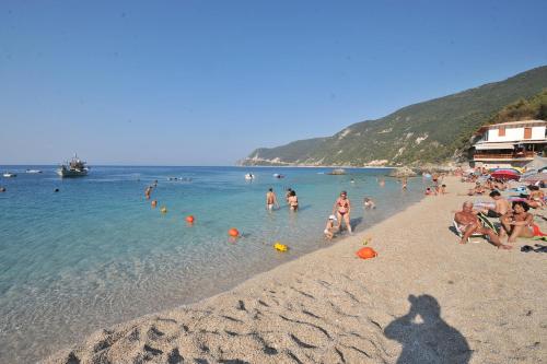 a group of people in the water at a beach at Hotel Agios Nikitas in Agios Nikitas