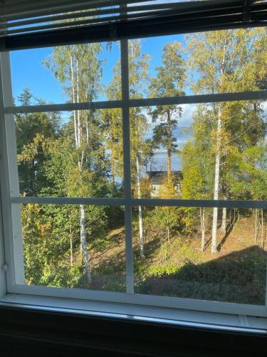 a window with a view of a forest at Pan Golf & Spa Villas in Imatra