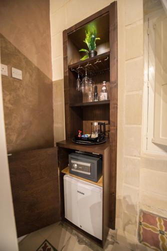 a kitchen with a small appliance on a shelf at Casa Maria Tereza in Cospicua