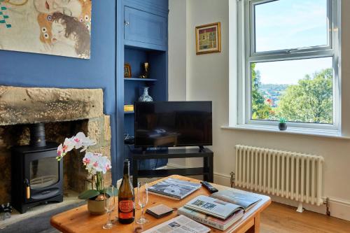 a living room with a table and a fireplace at Finest Retreats - Peak View in Two Dales