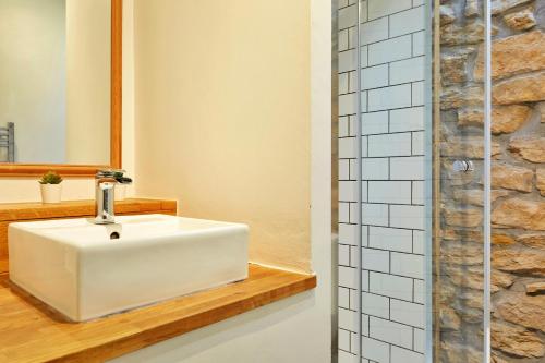 a bathroom with a white sink and a shower at Finest Retreats - Peak View in Two Dales