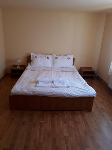 a bedroom with a bed with two towels on it at Casa Ionel si Dani in Fundata