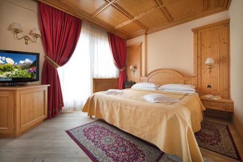 En eller flere senge i et værelse på Hotel Valtellina
