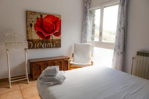 a bedroom with a white bed and a window at Apartamento Everest parque natural Coma Pedrosa in La Massana