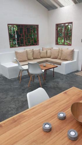 a living room with a couch and a table at Casa Bolita in Dos Brazos