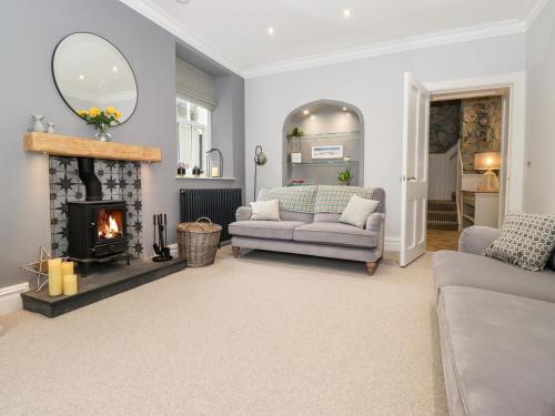 a living room with a couch and a fireplace at Eller Close House in Ambleside