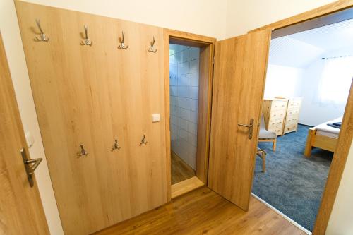 a bathroom with wooden doors in a room at Chata Markétka in Dobré