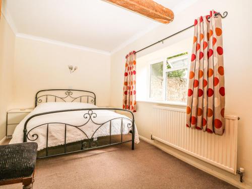 a bedroom with a bed and a window at Byre Cottage 3 in Pulborough