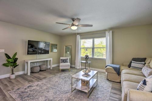 a living room with a couch and a tv at 3 Blocks to the Coast! Cozy Sarasota Retreat in Sarasota