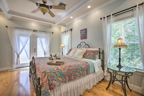a bedroom with a bed and a table with a lamp at Waveland Family House, 4-Minute Drive to the Beach in Waveland