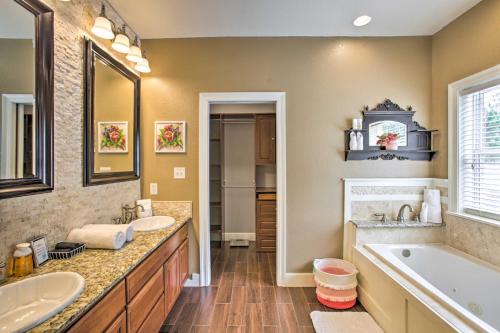 a large bathroom with two sinks and a tub and a tubermott at Waveland Family House, 4-Minute Drive to the Beach in Waveland