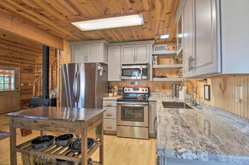 a kitchen with stainless steel appliances and a wooden ceiling at Large Deck, Grill Pet-Friendly Show Low Retreat! in Show Low