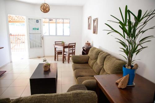 a living room with a couch and a table at Oca Delfim in Delfim Moreira