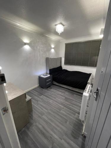 a bedroom with a bed and a desk in it at Newly refurbished modern 2 bedroom flat in Trimley Heath