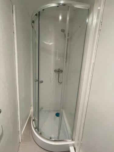 a shower with a glass door in a bathroom at Newly refurbished modern 2 bedroom flat in Trimley Heath